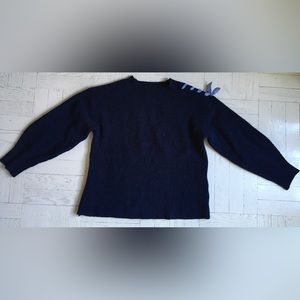 Navy cotton sweater with blue stripe bows on shoulders.